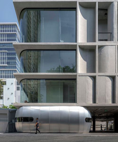 ASWA installs golf driver-like steel entrance along curved concrete panel facade in bangkok